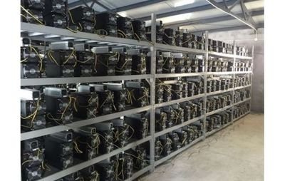 A large mining farm with rows of ASICs, showcasing the scale of modern Bitcoin mining operations